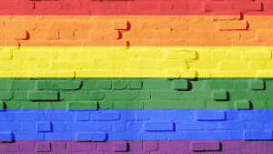 A brick wall painted to look like a rainbow in celebration of Pride Month