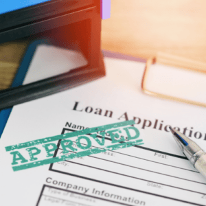 Loan application with approved stamp on top of it
